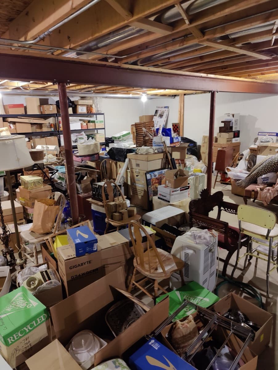 Unfinished basement with household contents before ECOS began work